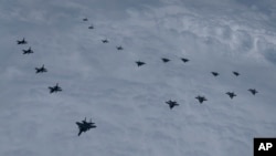 In this photo provided by South Korea Defense Ministry, US and South Korean fighter jets fly in formation during a joint drill, June 7, 2022. (South Korean Defense Ministry via AP)