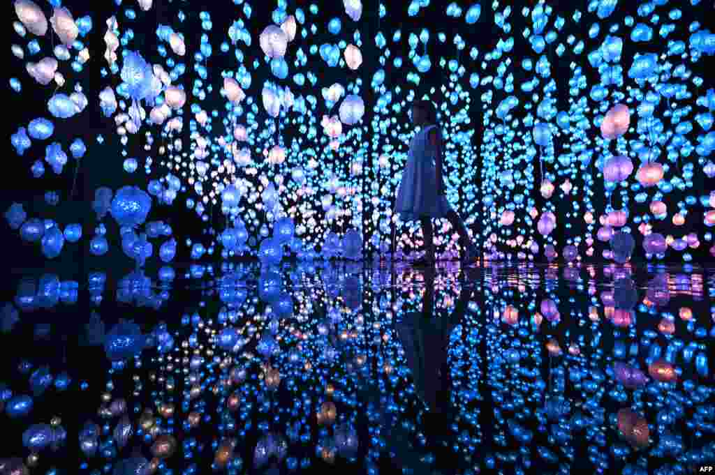 A girl attends the exhibition "Pipilotti Rist: Your Brain to Me, My Brain to You," a new large-scale, site-specific installation by Swiss artist Pipilotti Rist at the National Museum of Qatar in Doha.