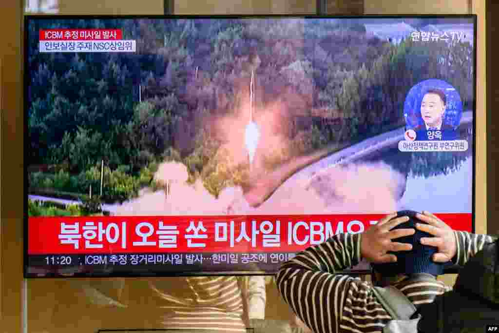 A man watches a television showing a news broadcast with file footage of a North Korean missile test, at a railway station in Seoul. A suspected intercontinental ballistic missile launched by North Korea on Nov. 18, 2022, is believed to have fallen in Japan's exclusive economic waters, Japanese Prime Minister Fumio Kishida said.