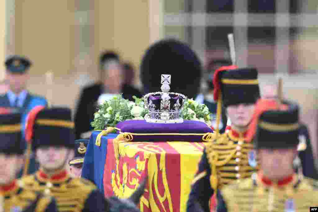 The coffin of Queen Elizabeth II, adorned with a Royal Standard and the Imperial State Crown and pulled by a Gun Carriage of The King's Troop Royal Horse Artillery, is pictured during a procession from Buckingham Palace to the Palace of Westminster in London, Sept. 14, 2022.