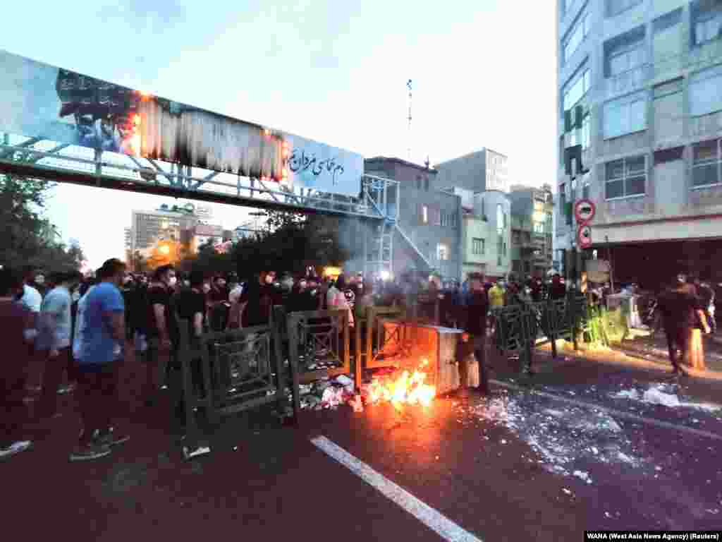 People light a fire during a protest over the death of Mahsa Amini, a woman who died after being arrested by the Islamic republic's "morality police", in Tehran, Iran, Sept. 21, 2022.