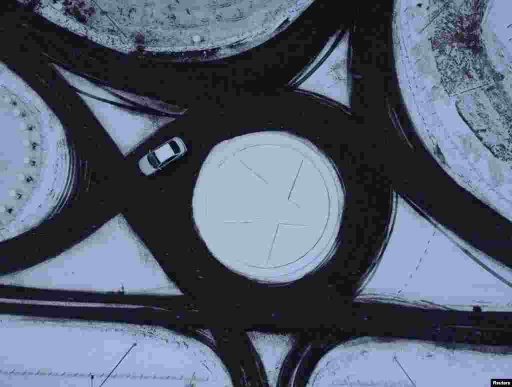 A car drives along a road in the Siberian town of Tara in the Omsk region, Russia.