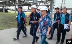 In this handout photo taken from video released by Russian Defense Ministry Press Service on Sept. 2, 2022, International Atomic Energy Agency (IAEA) director Rafael Grossi, center, and IAEA members inspect the Zaporizhzhia nuclear power plant in Enerhodar, southeastern Ukraine, Sept. 1, 2022.