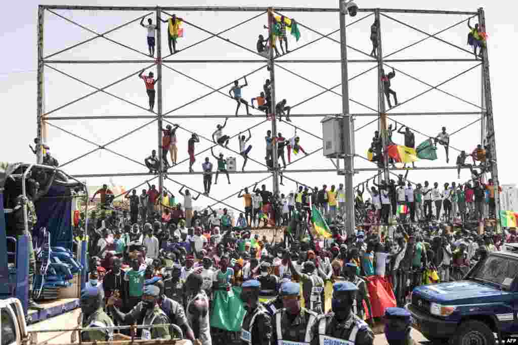 Supporters cheers ahead of the Senegalese football team's arrival in Dakar after winning the Africa Cup of Nations for the first time.