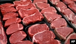 FILE - Beef products are displayed for sale at a grocery store in McLean, Va.