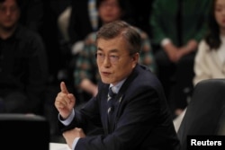 FILE - Moon Jae-in, the presidential candidate of the Democratic Party of Korea, speaks during a televised debate in Goyang, South Korea, April 25, 2017.