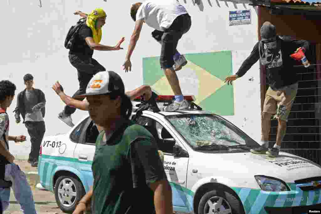 Demonstrators attack a vehicle belonging to the municipal government's traffic police during protests in Fortaleza, Brazil, June 19, 2013. 
