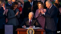 President Joe Biden signs the "Infrastructure Investment and Jobs Act" during an event on the South Lawn of the White House, Nov. 15, 2021.