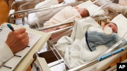 FILE - This Thursday, Feb. 16, 2017 file photo shows newborn babies in the nursery of a postpartum recovery center in upstate New York.