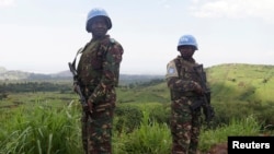 FILE - UN peacekeepers from Tanzania hold their weapons as they patrol outside Goma.
