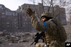 FILE - A Ukrainian serviceman guards his position in Mariupol, Ukraine, on March 12, 2022. The image is part of the documentary film "20 Days in Mariupol," which has been nominated for an Academy Award in the category of best documentary.