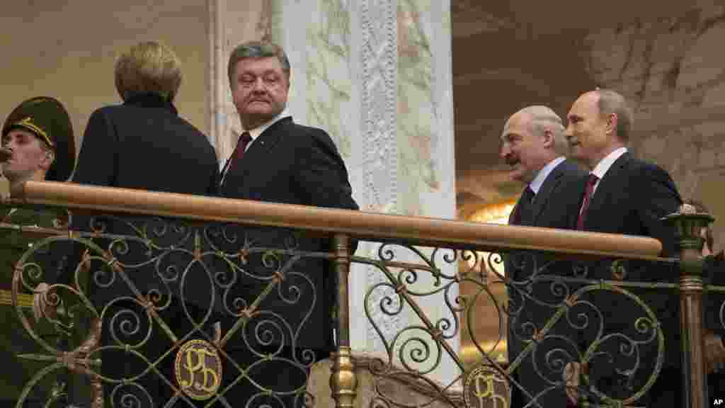 German Chancellor Angela Merkel, left back to a camera, Ukrainian President Petro Poroshenko, second left, Belarusian President Alexander Lukashenko, second right, and Russian President Vladimir Putin, walk together to continue their peace talks in Minsk.