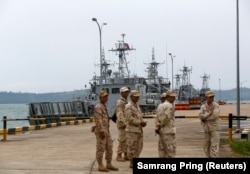 Sailors stand guard near petrol boats at the Cambodian Ream Naval Base, July 26, 2019. (Samrang Pring/Reuters)