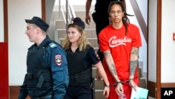 WNBA star and two-time Olympic gold medalist Brittney Griner is escorted to a courtroom for a hearing, in Khimki just outside Moscow, Russia, July 7, 2022. (AP Photo/Alexander Zemlianichenko)