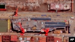 FILE - This satellite image from Maxar Technologies shows construction of China's Type 003 aircraft carrier at the Jiangnan Shipyard northeast of Shanghai, China, May 31, 2022.