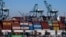 Cargo containers sit stacked at the Port of Los Angeles, on Oct. 20, 2021, in San Pedro, Calif. Dockworkers and shipping companies at 29 ports on the U.S. West Coast say they plan to keep cargo moving as they negotiate a contract. The last one expired Friday.