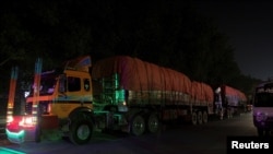 FILE: Supply trucks carrying aid shipments containing wheat to Afghanistan, move in a convoy near Lahore, Pakistan Feb. 23, 2022.