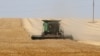 FILE - A farmer uses a combine harvester to harvest wheat on a field near Izmail, in Ukraine's Odesa region, June 14, 2022, amid Russia's invasion of its neighbor.
