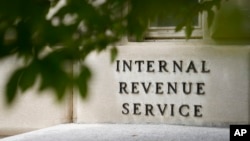 FILE - The sign outside the Internal Revenue Service building is seen. May 4, 2021, in Washington. 