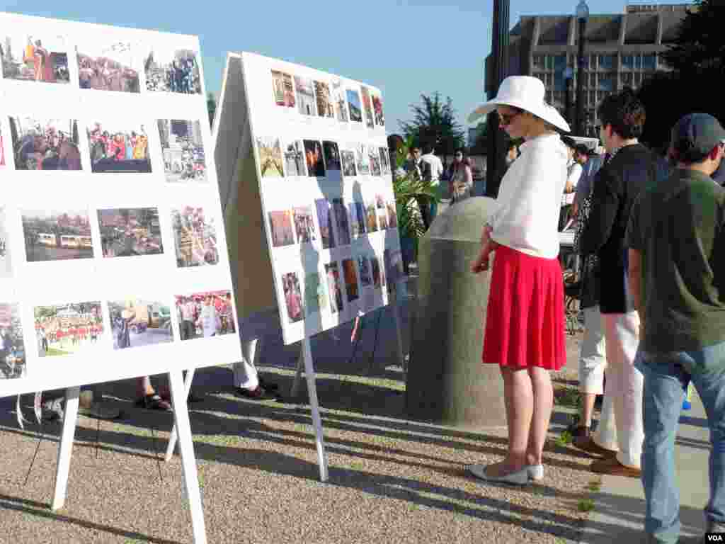 A woman looks at photos at a memorial in Washington for the crackdown in Tiananmen Square, June 3, 2014. (Zhi Yuan/VOA)