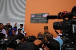 FILE - Chhum Socheat, a spokesperson for Cambodia’s defense ministry, shows a group of invited journalists the US-funded Boat Maintenance Facility building during a rare media tour at Ream Naval Base in Preah Sihanouk province, Cambodia, Friday, July 26, 2019. (Sophat Soeung/VOA Khmer)