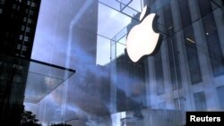 FILE PHOTO: The Apple Inc. logo is seen hanging at the entrance to the Apple store on 5th Avenue in New York