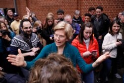 FILE - Presidential candidate Sen. Elizabeth Warren, D-Mass., speaks at a caucus at Roosevelt High School, Feb. 3, 2020, in Des Moines, Iowa.