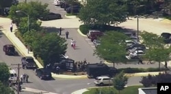 In this frame from video, people leave The Capital Gazette, a newspaper in Annapolis, Md., after multiple people had been shot, June 28, 2018.