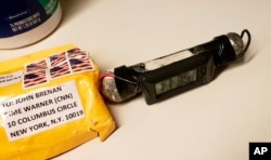 This image obtained Wednesday, Oct. 24, 2018, and provided by ABC News shows a package addressed to former CIA head John Brennan and an explosive device that was sent to CNN's New York office.