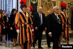 U.S. President Donald Trump and first lady Melania Trump pass a Swiss Guard as they arrive at the Vatican, May 24, 2017.