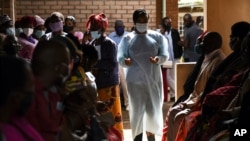 FILE - People wait to receive the AstraZeneca COVID-19 vaccine at Ndirande Health Centre in Blantyre, Malawi, March 29, 2021.