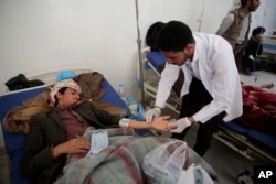 FILE- A man is treated for a suspected cholera infection at a hospital in Sana'a, Yemen, May 7, 2017.
