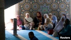 FILE - Muslim women gather for the first Friday prayers of the holy month of Ramadan in Rome's mosque, Sept. 5, 2008. 
