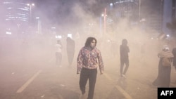 People clash with anti-riot police outside the Israeli consulate during a protest to show solidarity with Palestinians, in Istanbul early on Oct.18, 2023.