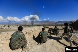 Afghan security forces take position during a gun battle between Taliban and Afghan security forces in Laghman province, Afghanistan, March 1, 2017.