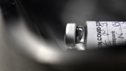 A picture taken shows on March 2, 2021, shows an empty vial of the Pfizer-BioNtech Covid-19 vaccine at a vaccination center in Garlan, western France. (Photo by Fred TANNEAU / AFP)