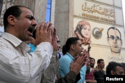 FILE - Journalists and activists protest against the restriction of press freedom and to demand the release of detained journalists, in front of the Press Syndicate in Cairo, Egypt, April 26, 2016.