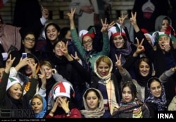 Iranian women watch the Iranian men's basketball team play Iraq in a FIBA World Cup Asian Qualifier at Azadi Indoor Stadium in Tehran, Feb. 25, 2018.