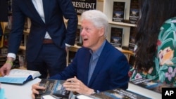 President Bill Clinton sign copies of "The President is Missing" at Book Revue on Thursday, June 28, 2018, in Huntington, New York. 