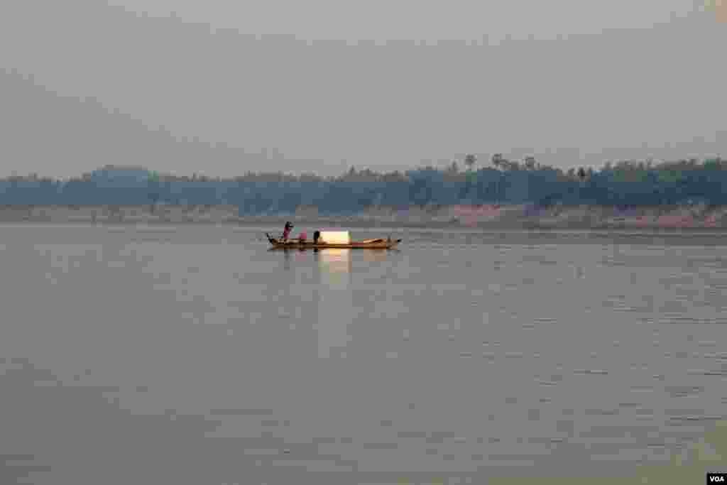 បុរស​ម្នាក់​ចែវ​ទូក​ឆ្លង​កាត់​ទន្លេ​មេគង្គ ក្នុង​ស្រុក​ឈ្លូង​ ខេត្ត​ក្រចេះ​នៃ​ប្រទេស​កម្ពុជា នៅ​ថ្ងៃ​ទី​១៦ ខែមិនា ឆ្នាំ២០១៤។ (នូវ ពៅលក្ខិណា)