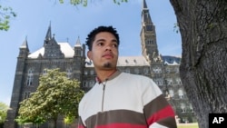 Shepard Thomas, a recent Georgetown University graduate and a descendant of slaves sold by Jesuits to keep the school open, poses for a portrait on the campus in Washington on Thursday, May 6, 2021. (AP Photo/Jacquelyn Martin)