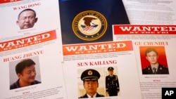 Wanted posters of Chinese military officers charged with cyber spying are on displayed May 19, 2014.