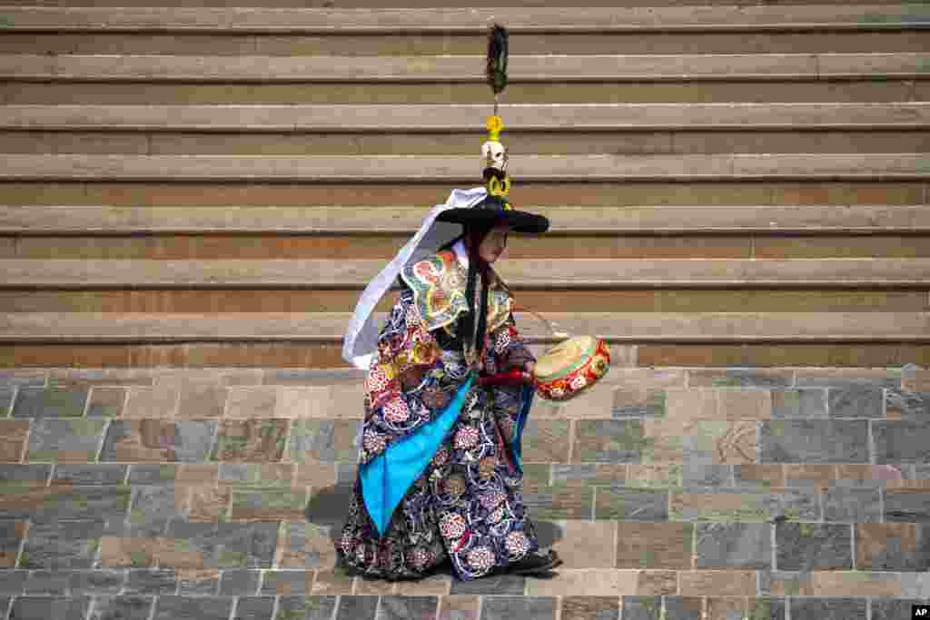 A Buddhist monk performs a traditional dance as part of the rituals during Gyalpo Losar, the Sherpa community's New Year celebration, at Shechen Monastery in Kathmandu, Nepal.