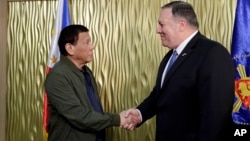 Philippine President Rodrigo Duterte, left, greets U.S. State Secretary Mike Pompeo upon arrival at Villamor Air Base in suburban Pasay city southeast of Manila, Philippines, Thursday, Feb. 28, 2019. 