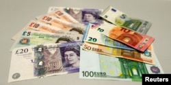 British pounds and Euro banknotes are pictured in a bank at the main train station in Munich, Germany, June 24, 2016 after Britain voted to leave the European Union in the EU BREXIT referendum.