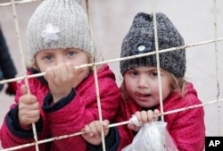 FILE - Syrian children wait to return to their country at the Turkish border crossing with Syria in the outskirts of Kilis, southeastern Turkey, Feb. 11, 2016.