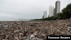 Plastic waste pile and debris are seen up near the beach in Panama City