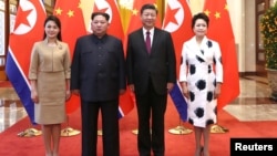 North Korean leader Kim Jong Un and wife Ri Sol Ju pose for a picture with Chinese President Xi Jinping and wife Peng Liyuan at the Great Hall of the People in Beijing, China in this picture released to Reuters on March 28, 2018. (Ju Peng/Xinhua via Reuters)