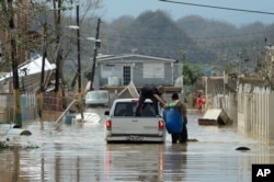 Residents evacuate after the passing of Hurricane Maria, in Toa Baja, Puerto Rico, Sept. 22, 2017.