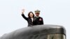 FILE - Taiwan's President Tsai Ing-wen, left, waves from a Zwaardvis-class submarine during a visit at Zuoying Naval base in Kaohsiung, southern Taiwan, March 21, 2017.